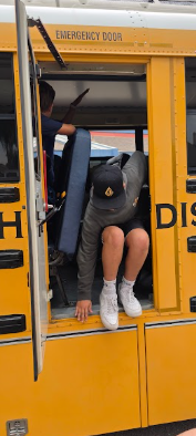 student exiting out of a school bus emergency door