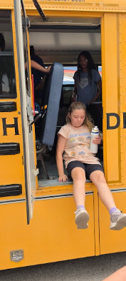 student exiting out of a school bus emergency door