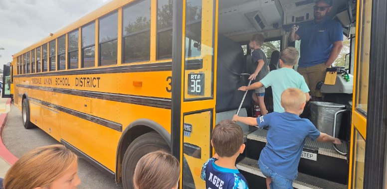 students standing outside the bus
