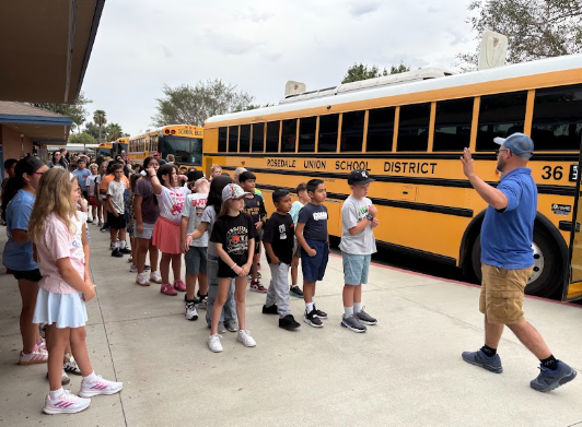 students standing outside the bus