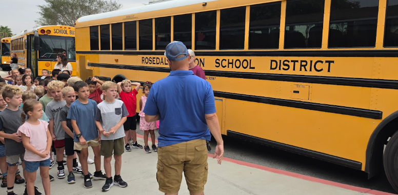 students standing outside the bus