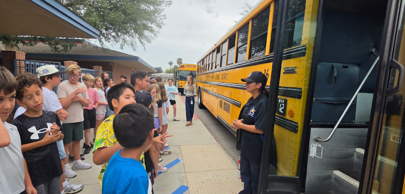 students standing outside the bus
