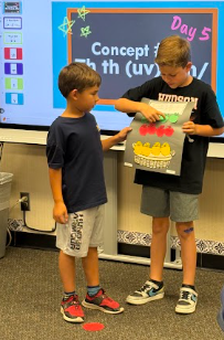 students presenting apple math posters