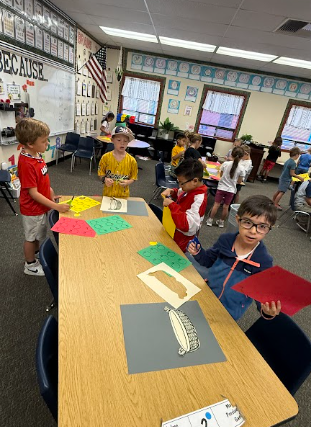 students working on math posters apples