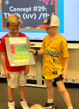 students presenting apple math posters