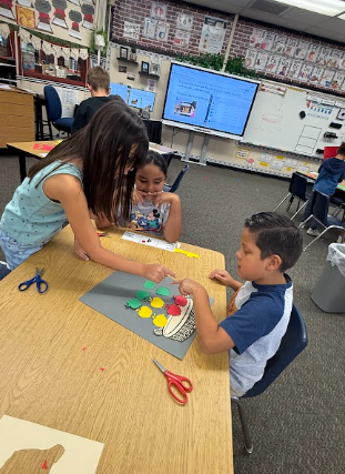students working on math posters apples