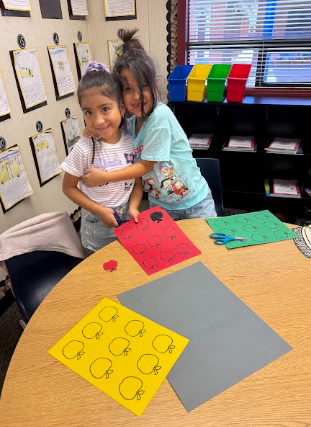 students working on math posters apples