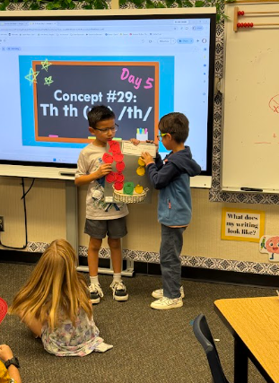 students presenting apple math posters