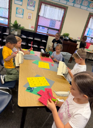 students working on math posters apples