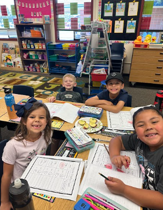 students at desks with apples