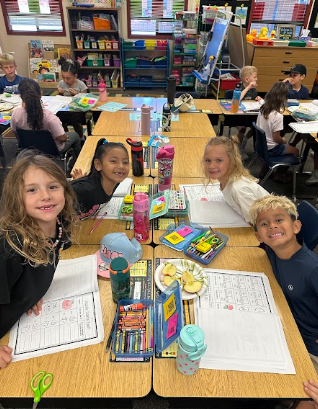 students at desks with apples