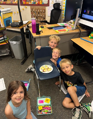 students on the floor  with apples