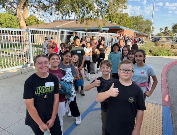 students gathered outside a bus getting ready to leave for camp