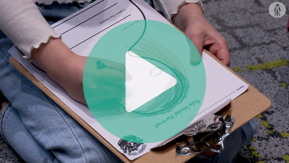 Picture of student drawing on a paper that reads "Role Model Portrait"