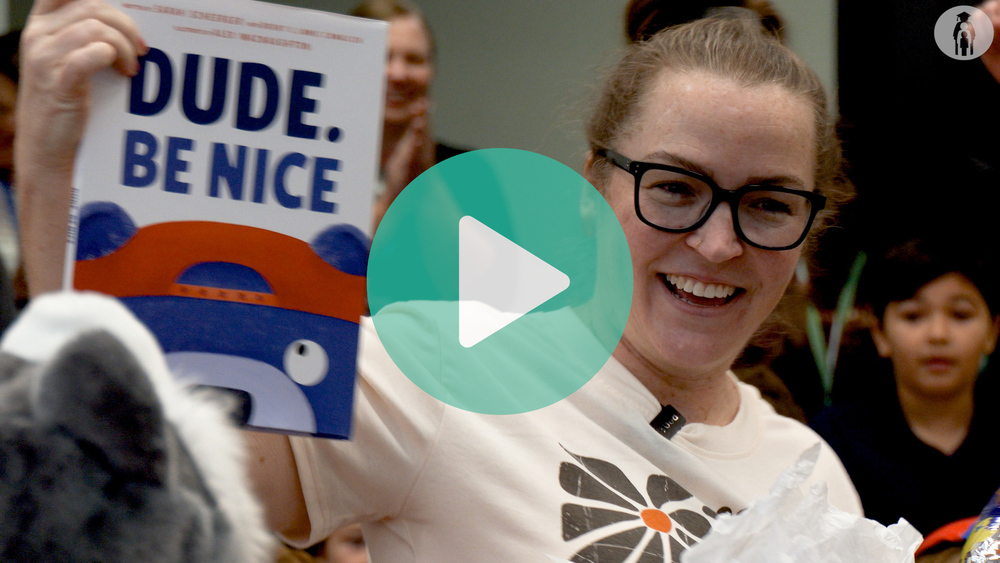 Picture of librarian holding up Dude, Be Nice book