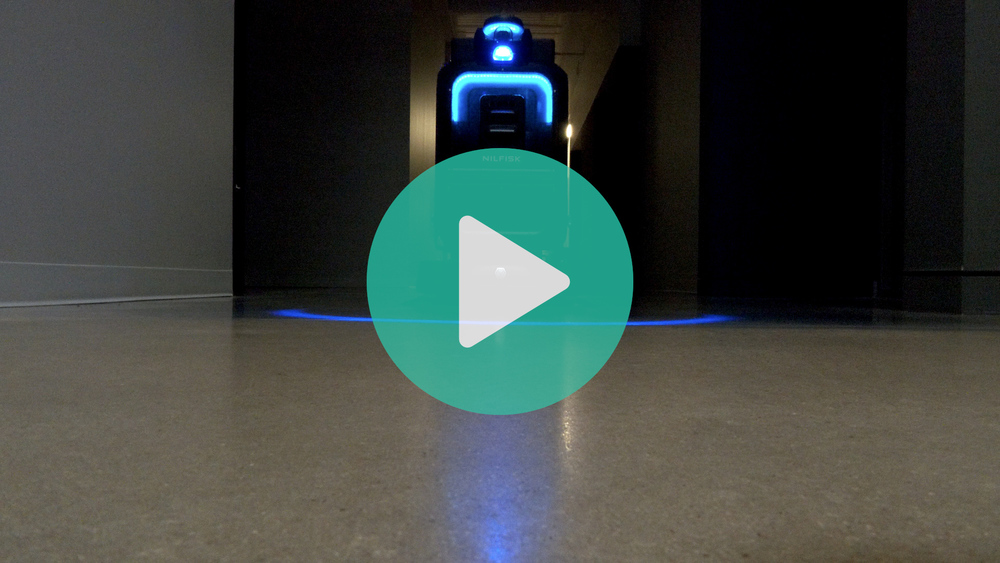 picture of cleaing robot going down the hallway.