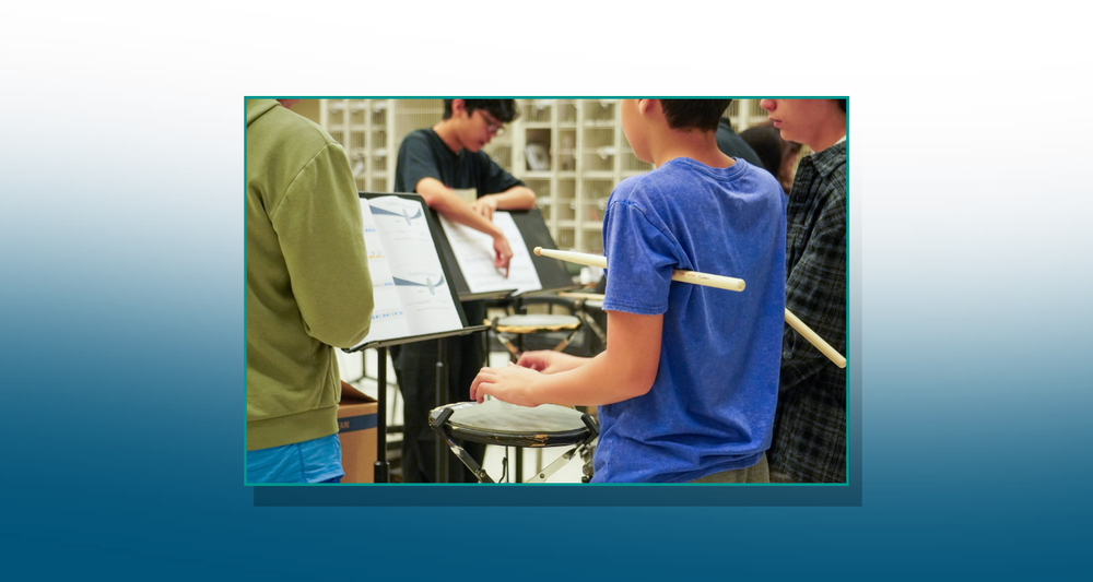 Child learning drums via united sound at Ridgeview Middle School