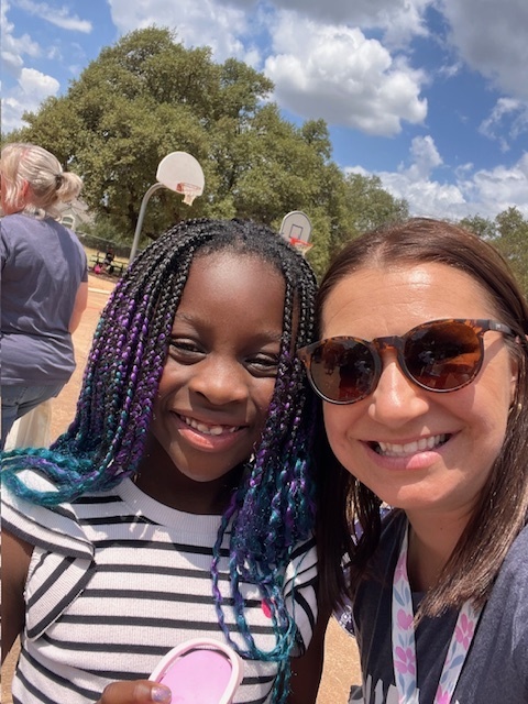 Mrs. Manning and kinder student smiling