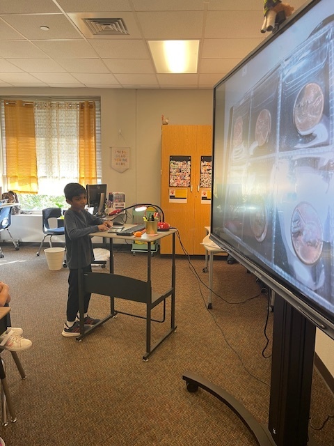 Student showing coins on the document camera.