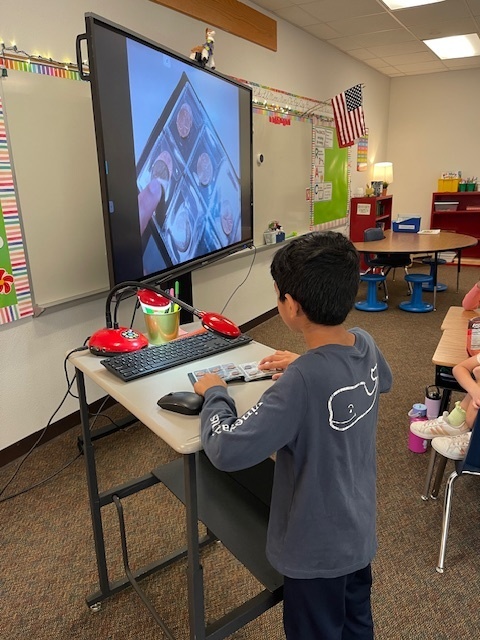 Student showing coins on the document camera.