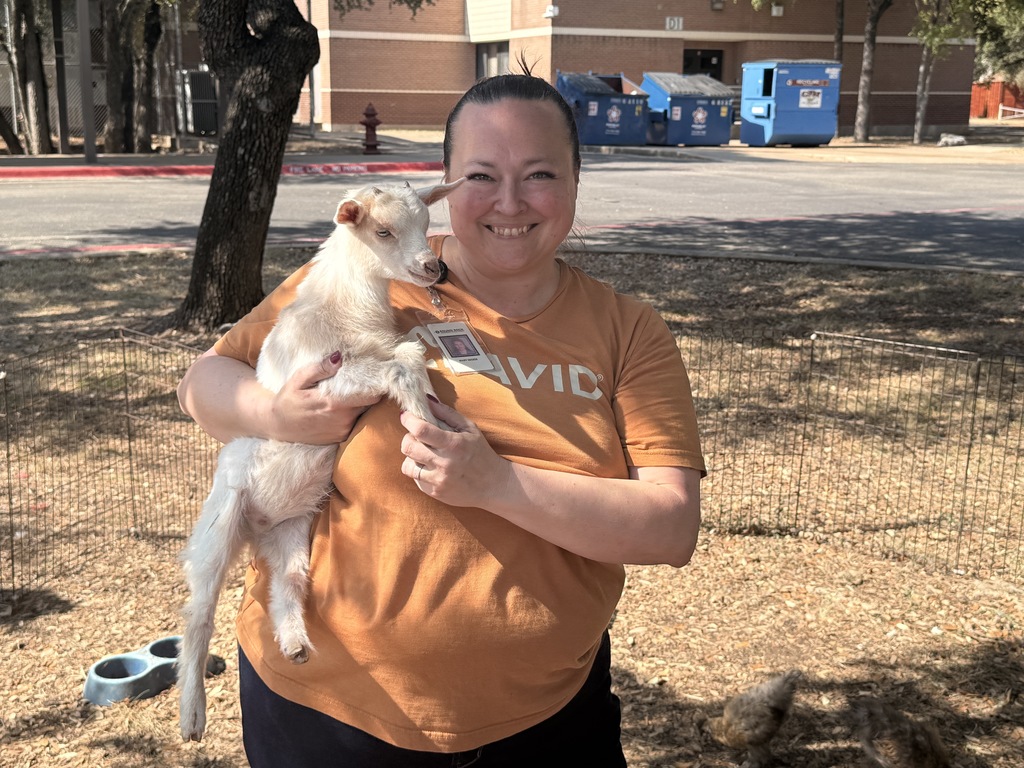 Ms. Decker holding a baby goat