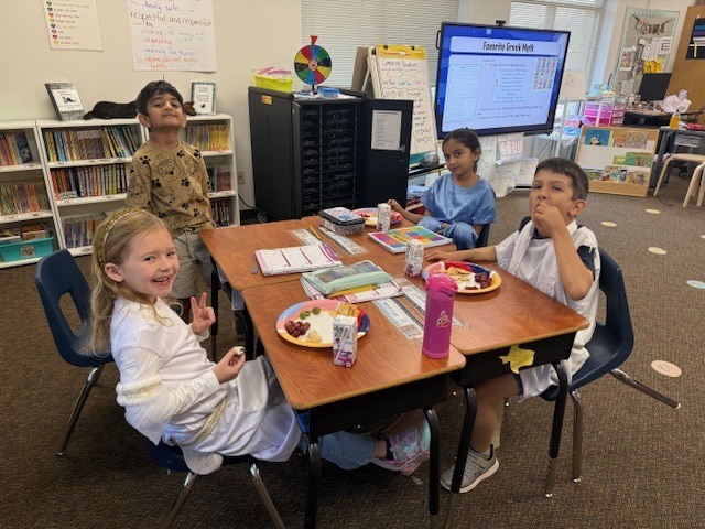 Students enjoying a Greek-themed snack.