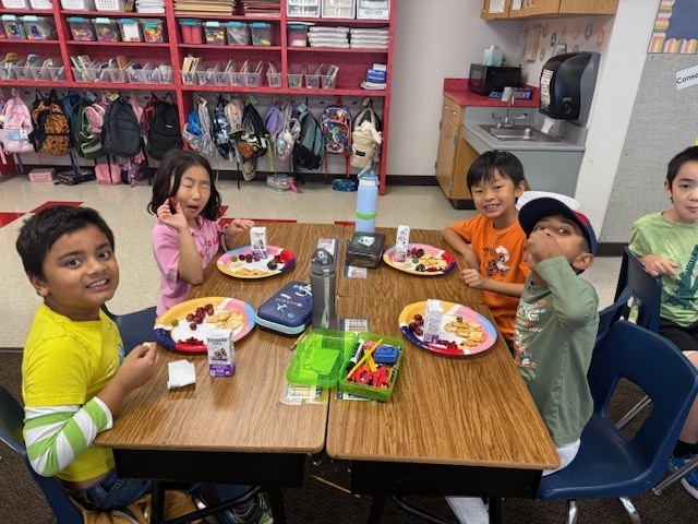 Students enjoying a Greek-themed snack.