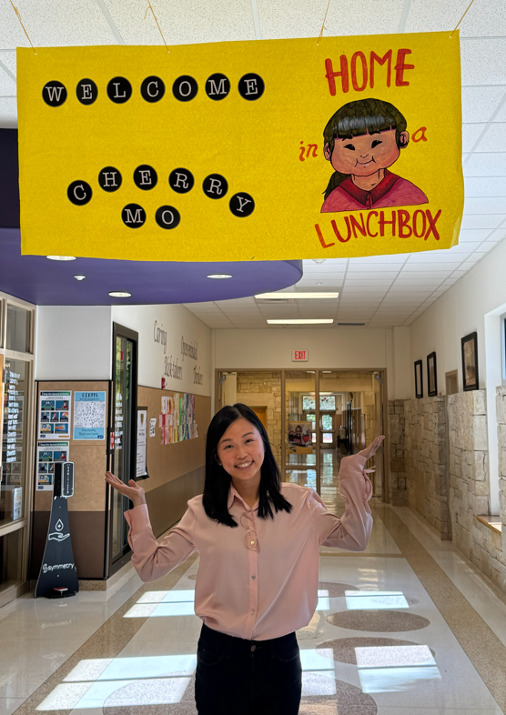 Author Cherry Mo standing under sign