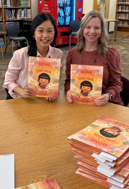 Author Cherry Mo and our COE librarian sitting holding books
