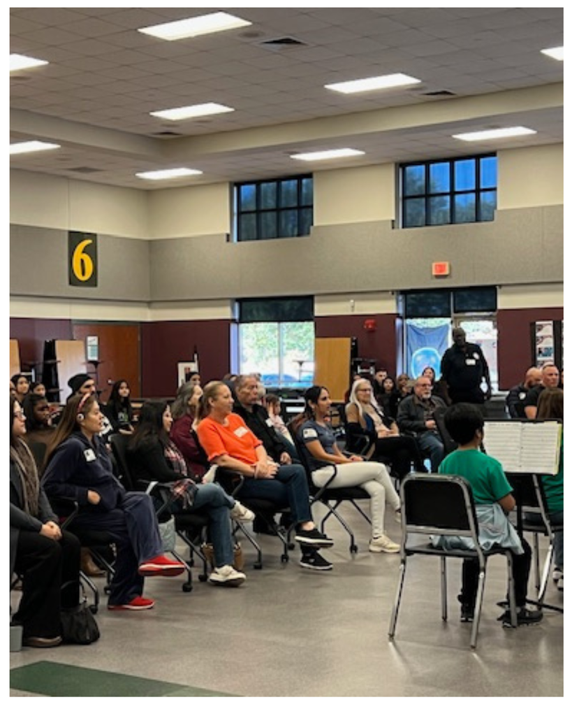 Hopewell's Veterans Day Program. Photo of parents and verterans sitting in the cafeteria.