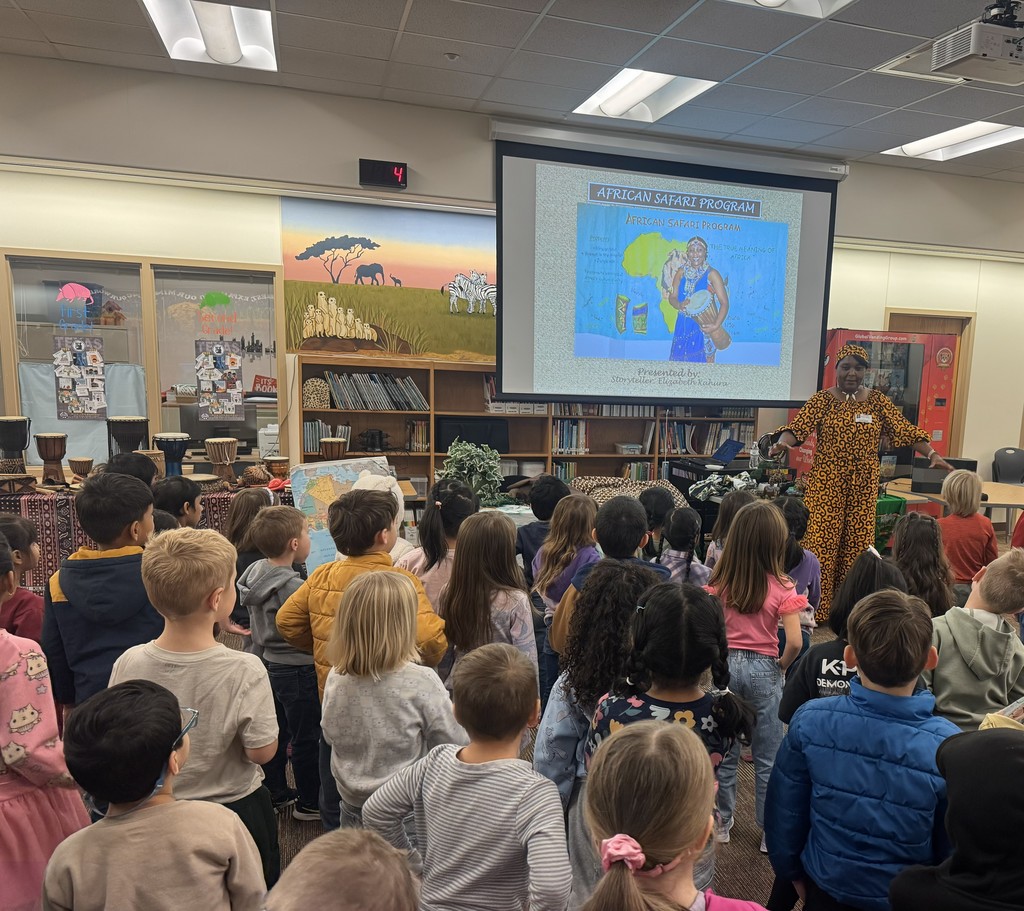 Students looking at the African Storyteller and screen