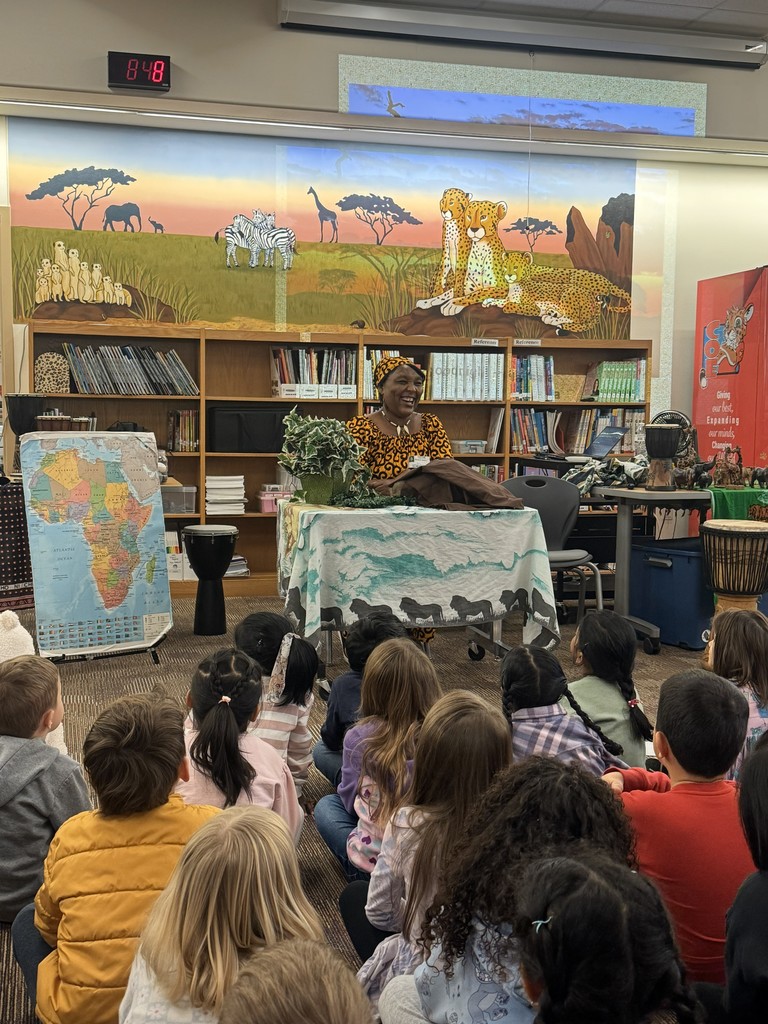 Students lookign at the African Storyteller sitting down