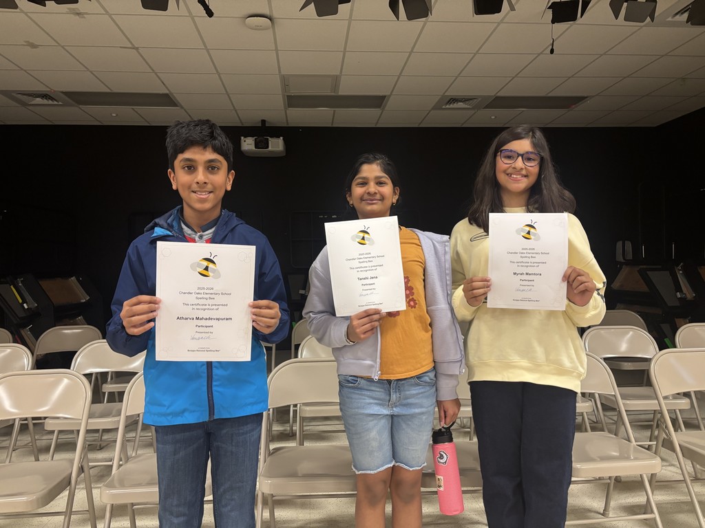 Students standing holding certificates