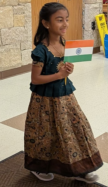 Student standing holding flag