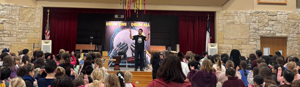 Man standing up on stage in front of students