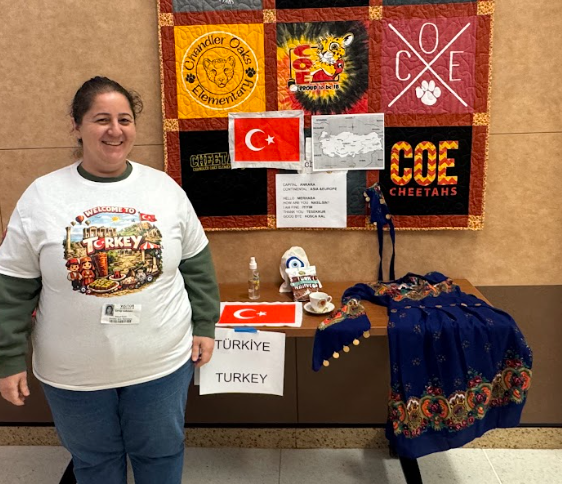 Picture of lady standing in front of booth with items from Turkey