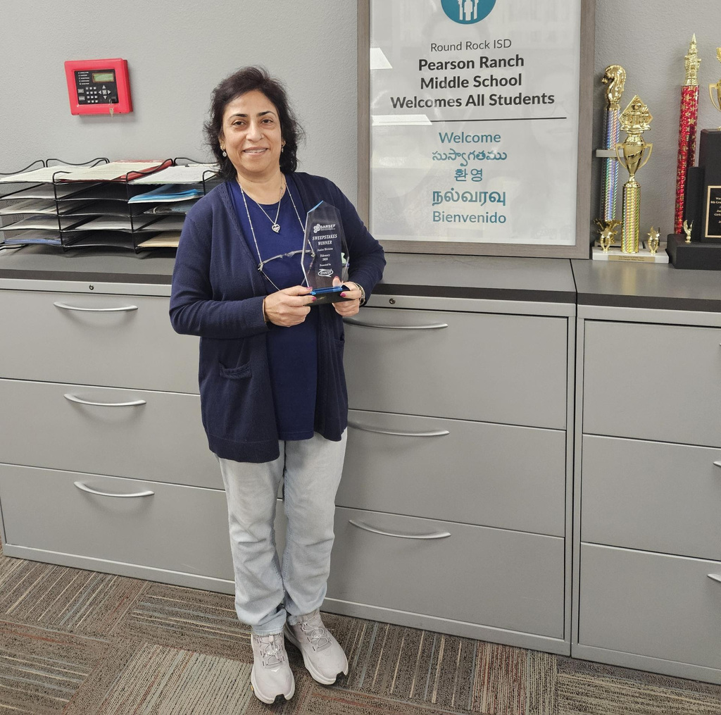 Ms. Kukreja holding her sweapstakes trophy.