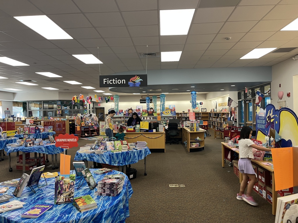 Picture of the book fair tables and books on the table with an ocean theme