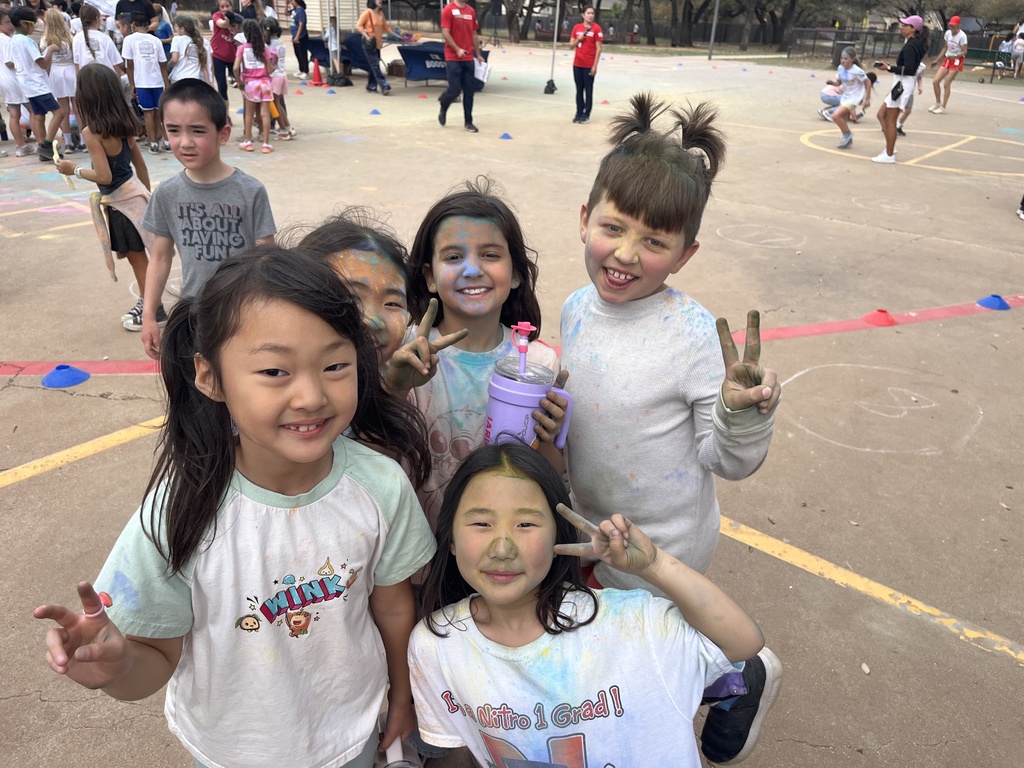 2nd graders covered in colors and smiling.