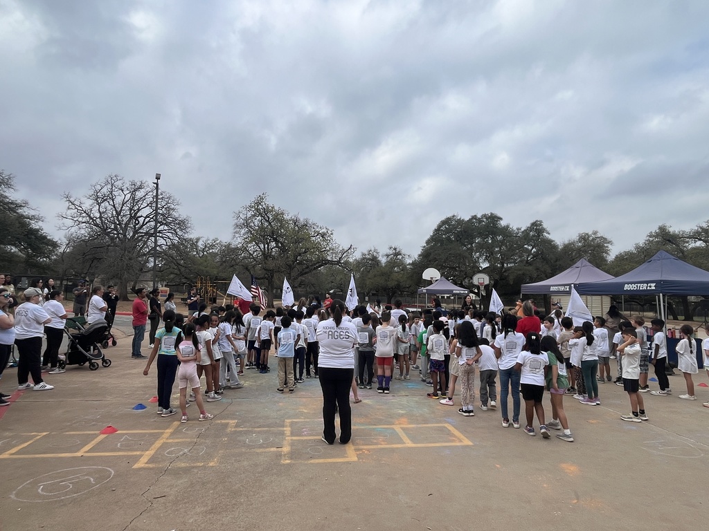 Teachers and 2nd graders singing the Star Bangled Banner