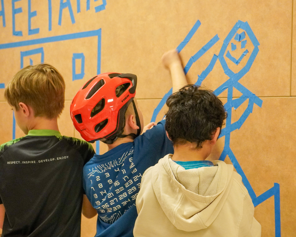 Big Art Day- Chandler Oaks Students make art on walls with blue tape.