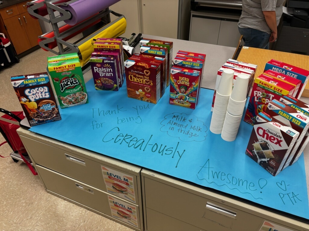 A variety of cereal boxes set out on a table for staff members
