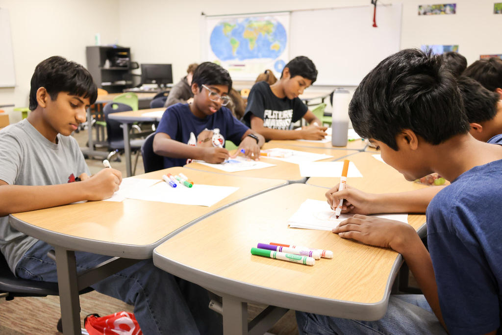 Middle school students at Visionary Voices Enrichment Event working on leadership projects and activities.