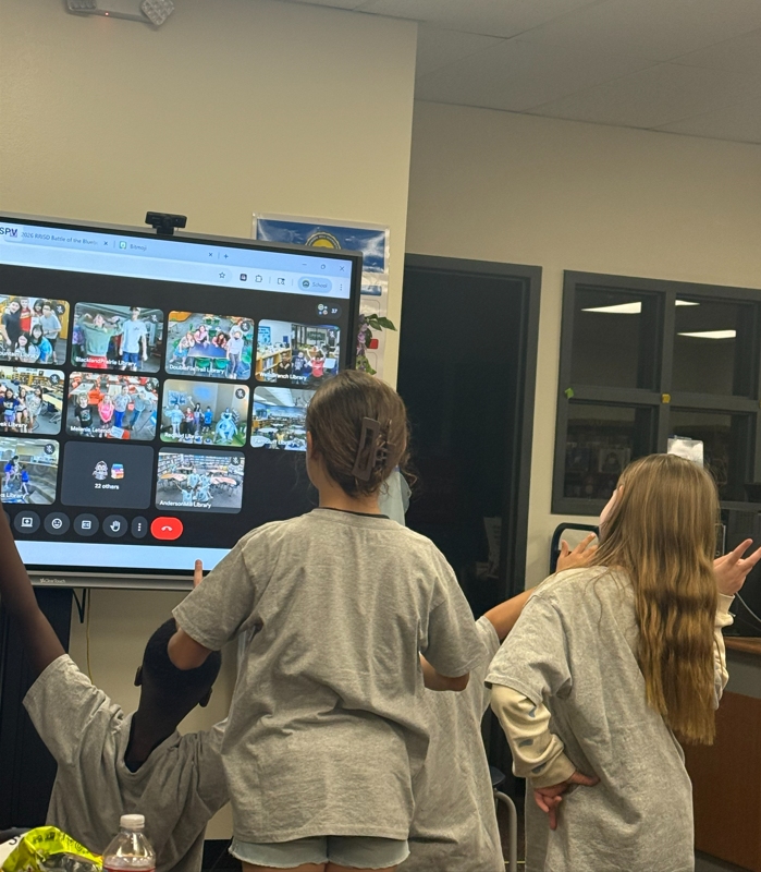 4 students posing for the Google Meet for a group pic. 