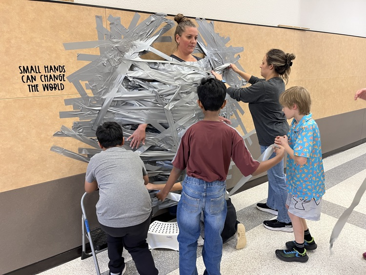 students taking principal to the wall