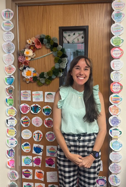 Photograph of our assistant principal standing in front of door with student thank you art