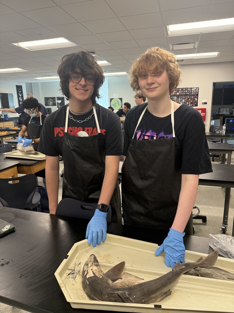 McNeil Aquatic Science Students Staning in Front of Dissected Dogfish Sharks