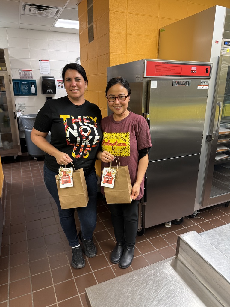 Decorative Image of our two LUNCH HEROES with gifts from Administration