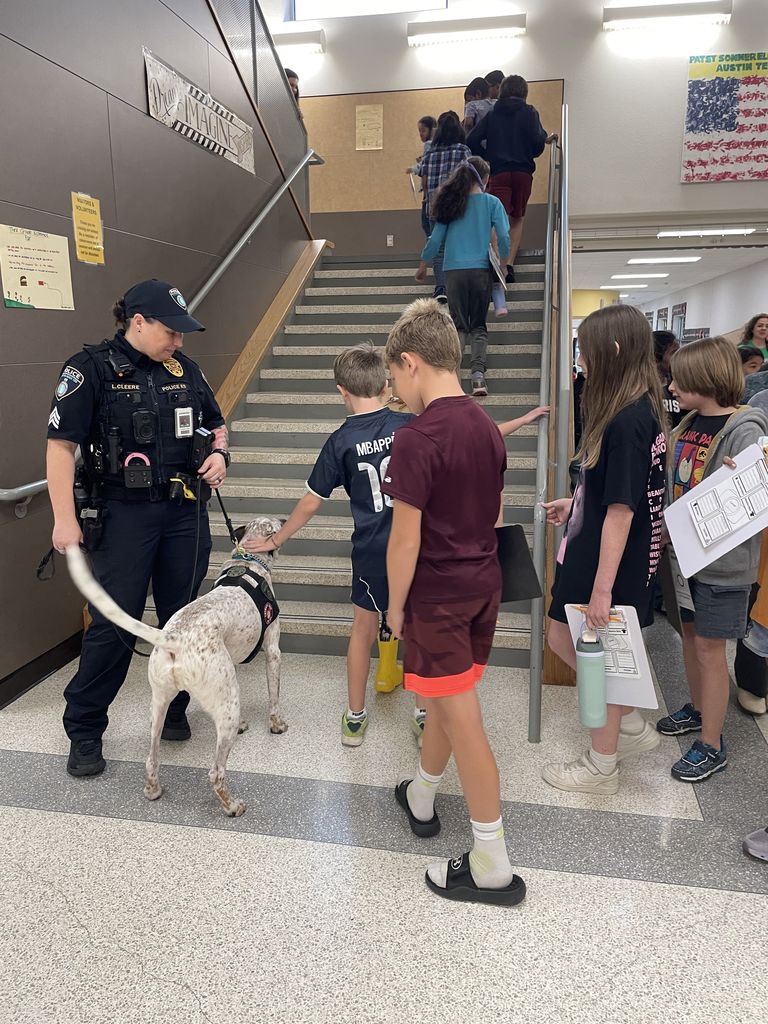 Students petting a service dog. 