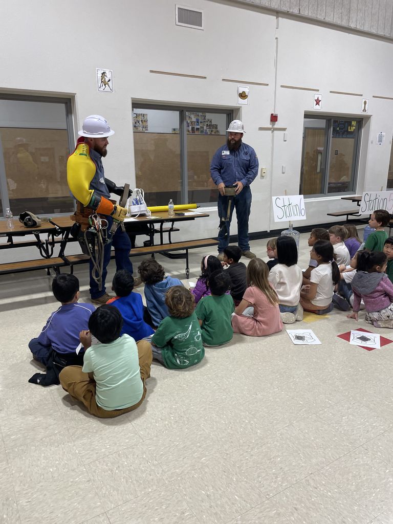 Students visiting with  people from the utility company. 